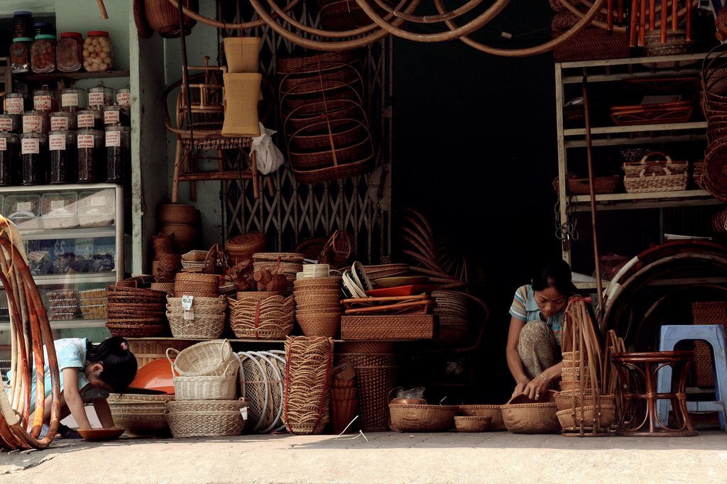A vendor arranges the products in her small business storefront in Hanoi, Viet Nam.